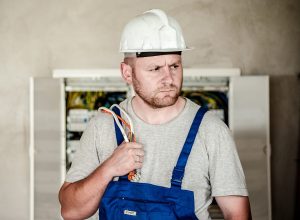 electrical-worker-carrying-wires