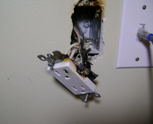 burnt-electrical-outlet-hanging-out-of-wall