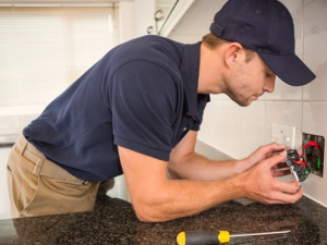 electrician-wiring-outlet-in-kitchen